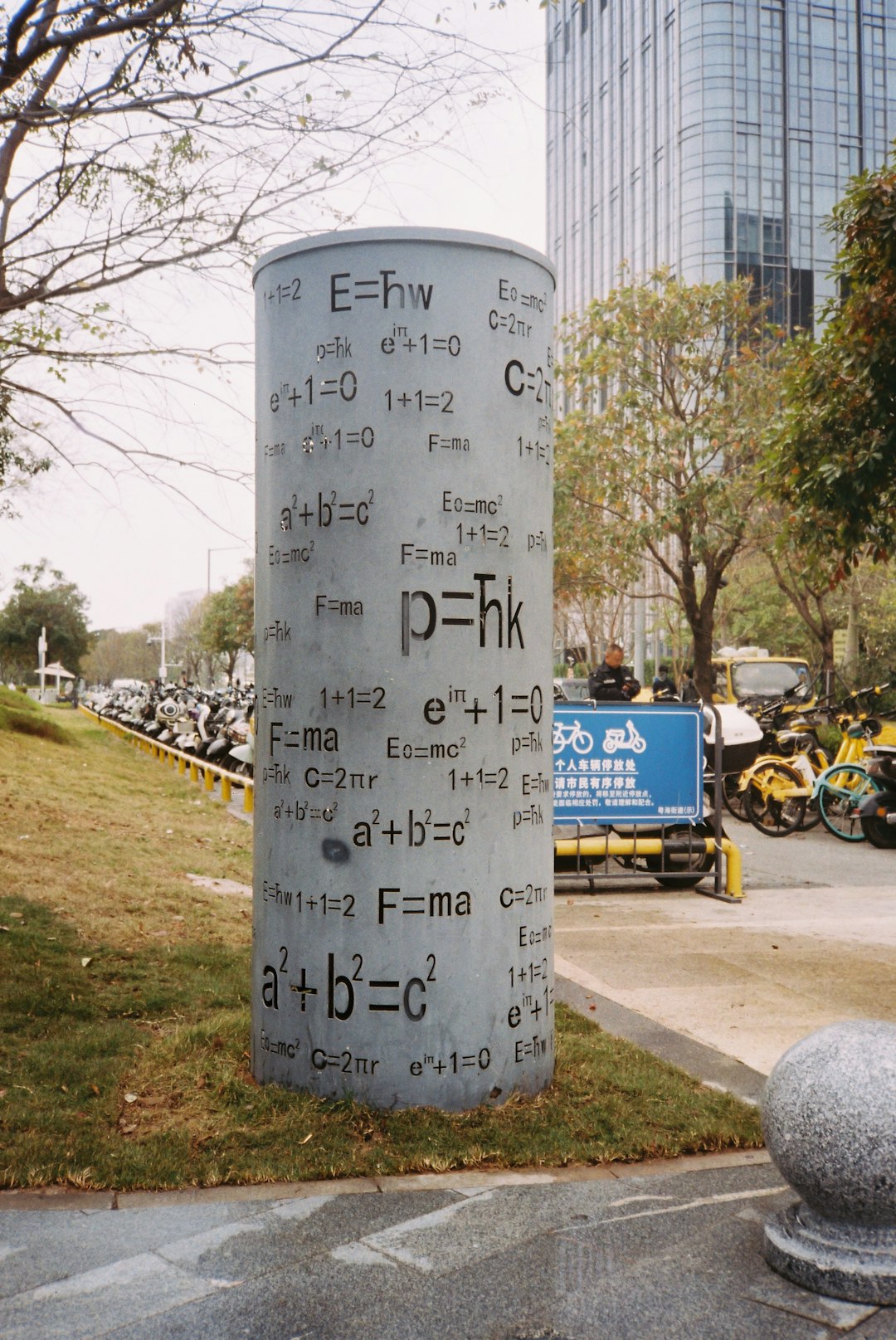 cylindrical-monument-with-physics-formulas-on-surface-zvwmsvrnzva