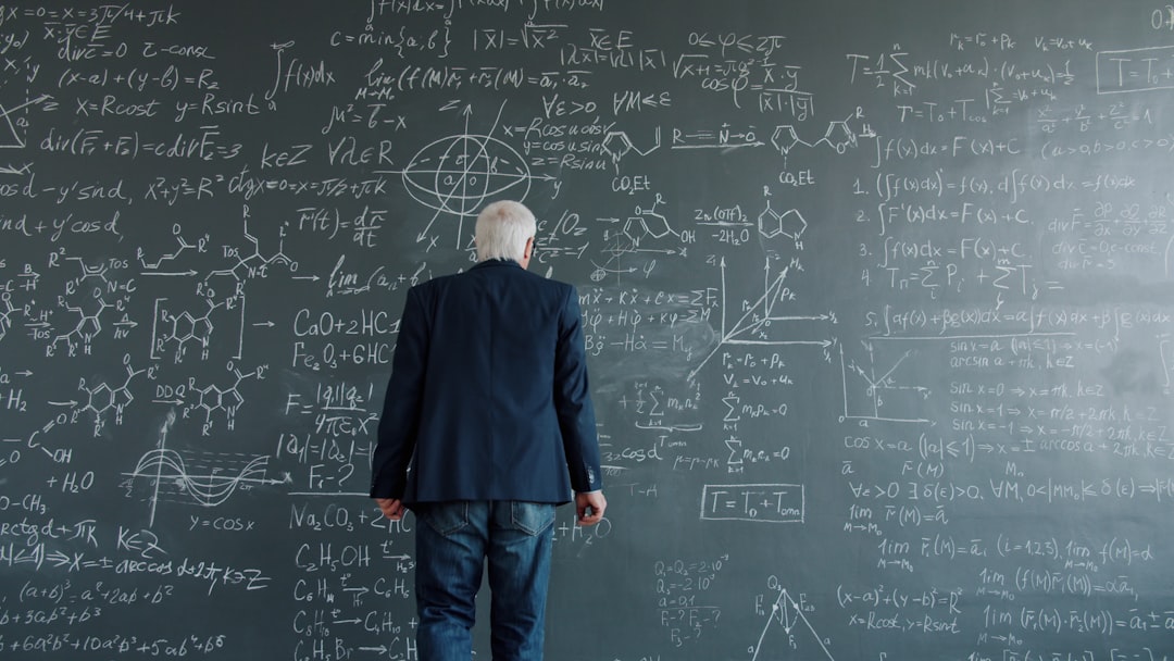 team-03 university teacher walking to chalkboard then writing formulas working at scientific project. People, lifestyle and science concept.