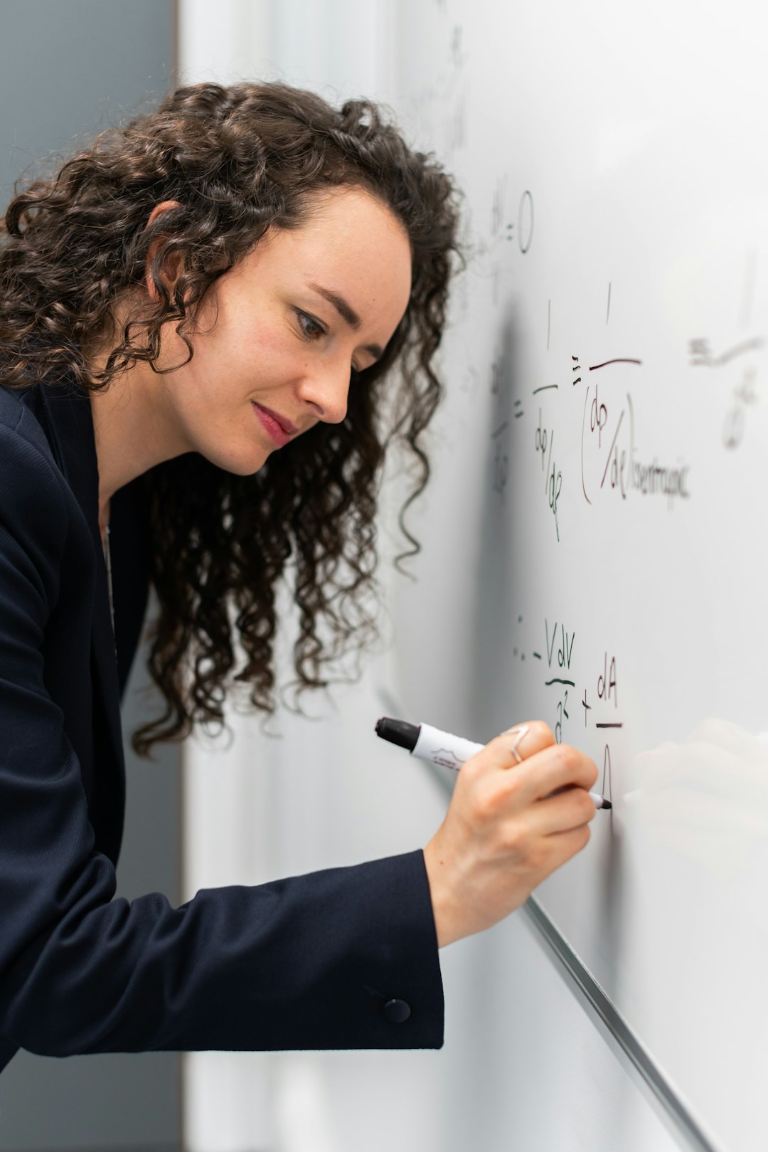 who-we-are Female aerospace engineer working on equations
