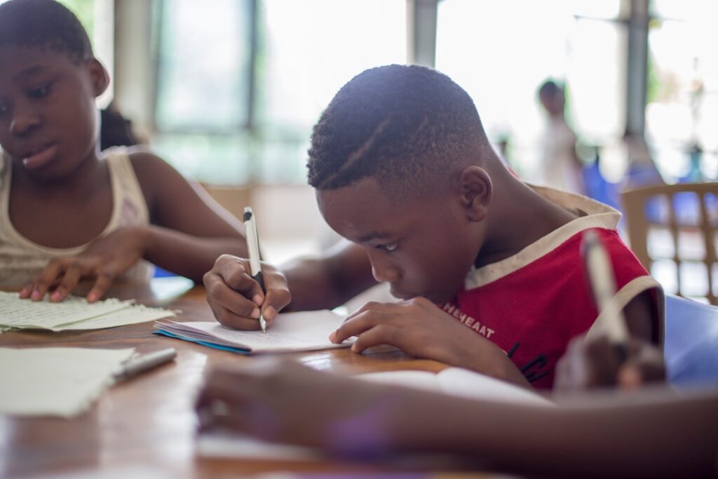 boy writing on printer paper near girl o5emzfdxedg